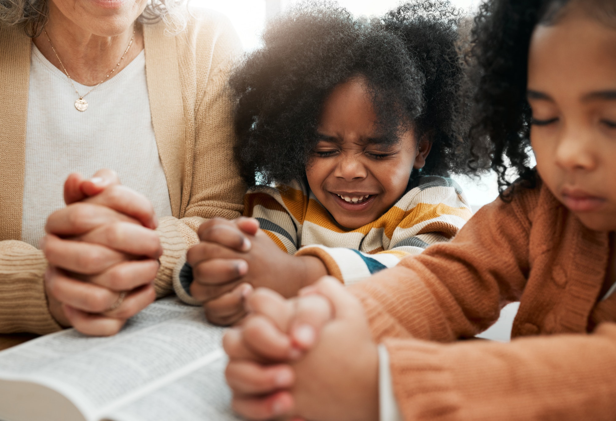 Bible, prayer or hands of grandmother with kids or siblings for worship, support or hope in Christi